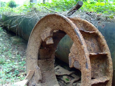 Overshot water wheel, and flume from a later era when the turbine above was installed